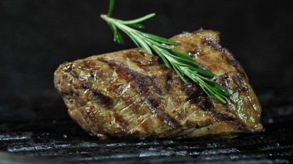 A large piece of meat fillet of beef or pork cooked charcoal barbecue in the American tradition. Sprig razmarina top