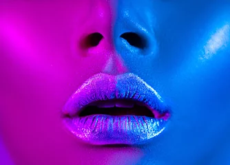 Acrylic prints Fashion Lips Beautiful sexy girl, trendy glowing makeup, metallic silver lips. High fashion model woman in colorful bright neon lights posing in studio. 