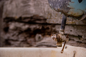 An old washbasin and a water tap