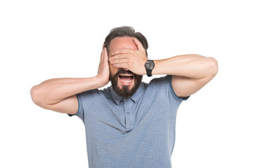 Fototapeta premium Screaming bearded man covering his eyes and ear with hands