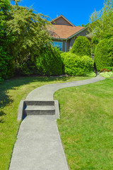 Concrete pathway with steps leading to the house