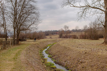 Small river through park in the winter without snow