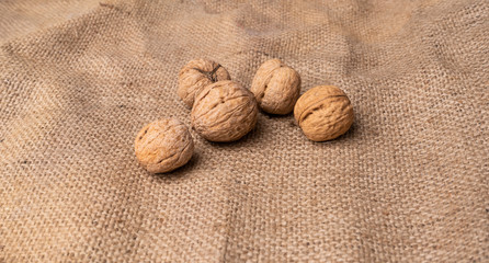 Walnut kernels on organic textile. Top view.