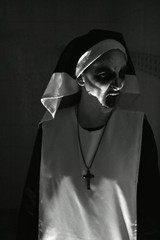 Terrifying face of nun on Halloween night. Nun of evil. Murder nun.