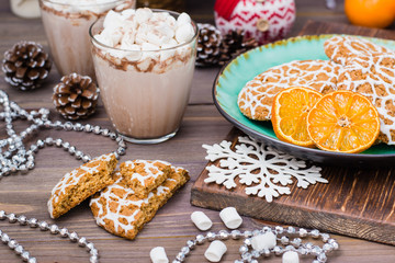 Christmas cookies and hot cocoa with marshmallows in glasses on the table in Christmas decorations