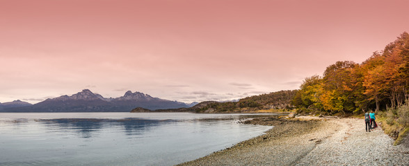 Obraz premium Two hikers in the trail in wonderful Tierra del Fuego National Park, Patagonia, Argentina, Autumn, sunset