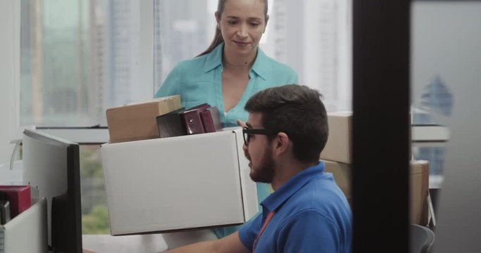 Hispanic Tech Support Man Fixing White Woman Computer in Office