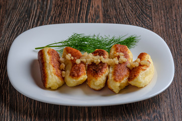 Breaded cheese and kefir sticks served in white plate. Made from cheese, flour and kefir.