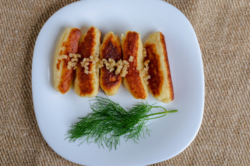 Breaded cheese and kefir sticks served in white plate. Made from cheese, flour and kefir.