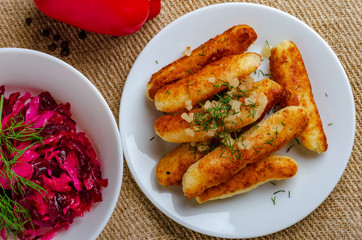 Breaded cheese and kefir sticks. Made from cheese, flour and kefir. Served with red salad.