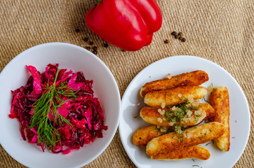 Breaded cheese and kefir sticks. Made from cheese, flour and kefir. Served with red salad.