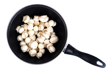 Pan with raw fresh champignons isolated on white background