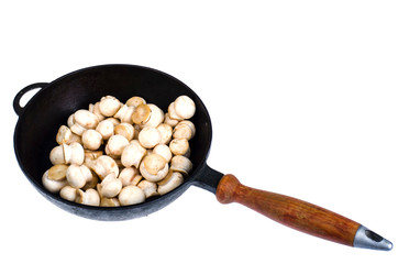 Pan with raw fresh champignons isolated on white background