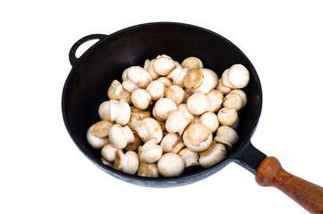 Pan with raw fresh champignons isolated on white background