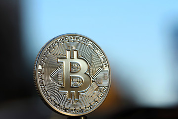 World cryptocurrency. Gold bitcoin standing on the edge