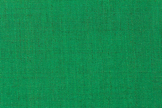 The structure is dark green fabric with a natural texture. Fabric background.