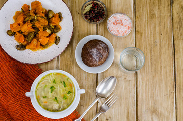 Noodles soup, vegetable stew, dinner set on table