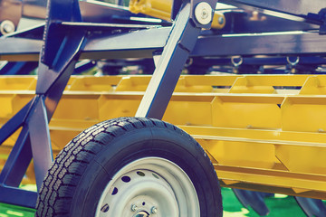 Agriculture equipment concept. Detailed closeup agricultural machinery, big wheels with tires. Outdoor shot