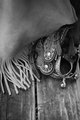 Black and white leather chaps and spurs before the work on the ranch begins.