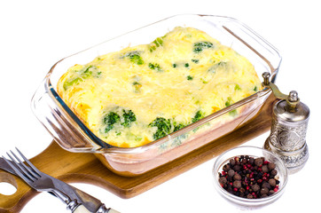 Omelette of eggs, broccoli, cheese in glass heat-resistant form, baked in oven