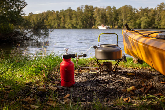 Camping stove and canoe at the lake, campground