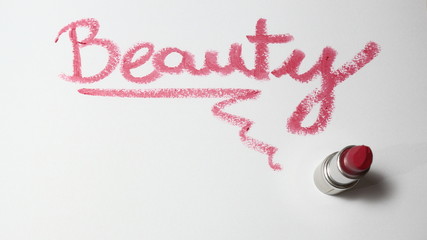 pink lipstick on a white background. Lipstick is an accessory worn by women and man. The concept of...