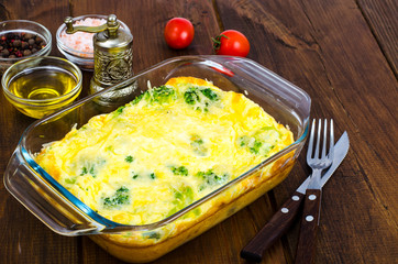Omelette of eggs, broccoli, cheese in glass heat-resistant form, baked in oven