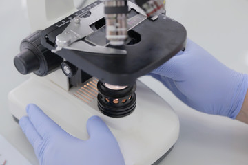 Young male Laboratory scientist working at lab with test tubes and microscope, test or research in clinical laboratory.Science, chemistry, biology, medicine and people concept.