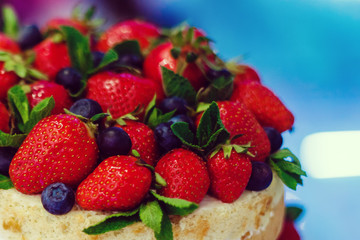 wedding cake with open biscuit shortcakes, cream and fruit. blueberries, strawberries, raspberries, red currants.
