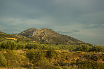 picturesque scenery of south European mountain landscape with big valley on foreground in evening romantic lighting, world travel concept