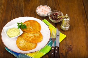 Vegetable rosti, golden fried potato pancakes with dips from cauliflower and sour cream