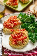 Oven baked chicken breasts topped with tomatoes and bell peppers