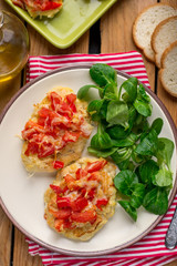 Oven baked chicken breasts topped with tomatoes and bell peppers