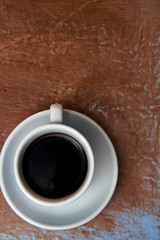 Black Coffee in a White cup with Old Wood Background Vertical