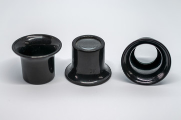 Three black magnifying eye pieces on a white background