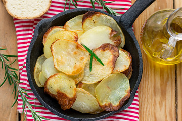 Healthy oven baked potato chips served with rosemary