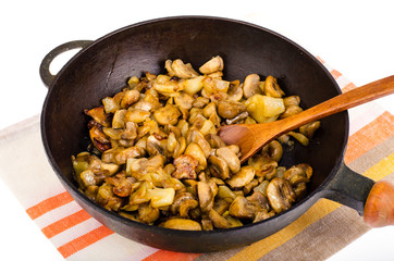 Cast iron pan, fried champignons with onions