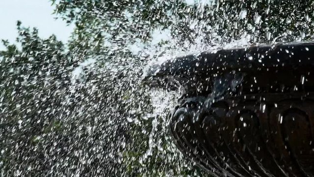 fountain. drops of water fall down. artificial water source. water pipes. a park. heavy rain. super slow motion