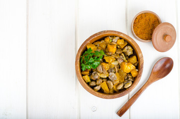 Wooden bowl with vegetable stew with mushrooms