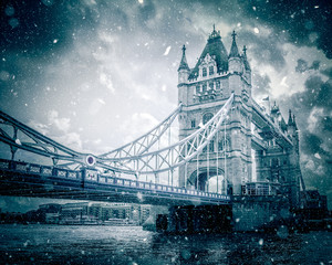 Winter at Tower Bridge London with snow falling on snowy day
