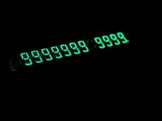 Green numbers in the dark. Old electronic numeric display. Hacking