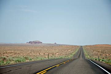 Fototapeta na wymiar Straight road with bumps in American desert