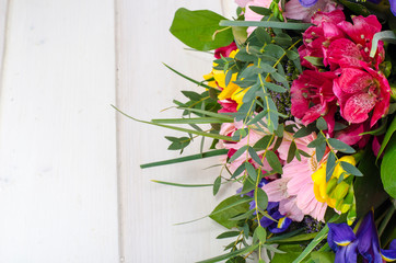 Beautiful bouquet of flowers on white wooden surface