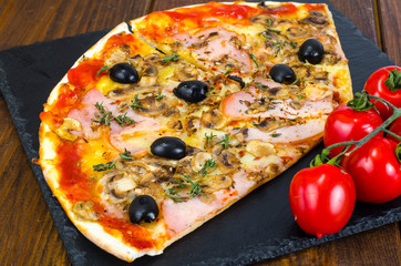 Pizza with Mozzarella cheese, ham, tomato sauce, salami, pepper, spices on wooden table background