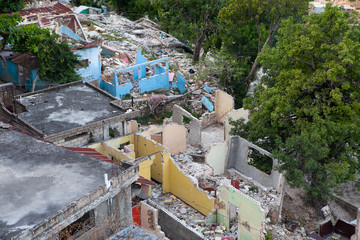 Collapsed homes are seen in Haiti after the 2010 earthquake. - obrazy, fototapety, plakaty