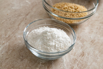 Healthy baking ingredients: sugar, grains of hazelnuts and crumbled biscuits. Bakery background frame.