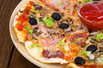 Six slices of pizza with different toppings on wooden board