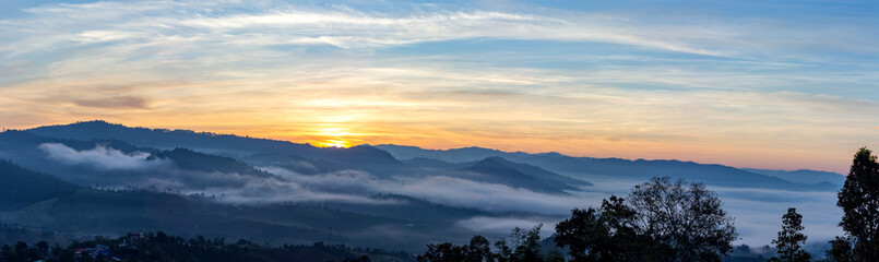 Mountain and foggy at morning time with orange sky, beautiful landscape in the thailand