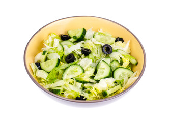 Healthy food. Vegetarian salad from iceberg, fresh cucumber and black olives