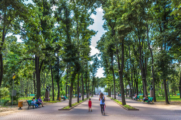 Chisinau, Moldavia - July 4th 2018 - Locals and tourists walking through a open air park with high...